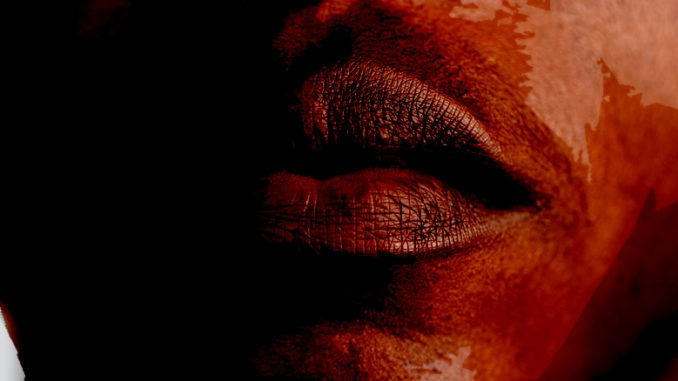 Close image of a mans closed mouth.